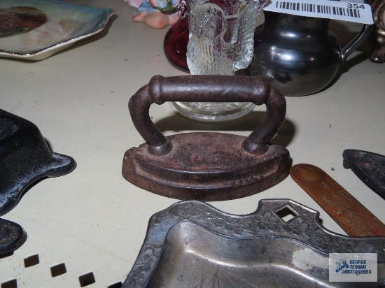 Cast iron decorations, cropper colored letter opener, and decorative crumb scraper and plate