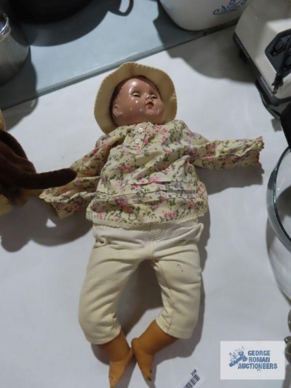 Vintage doll with plastic head and limbs, cloth body and open / close eyes