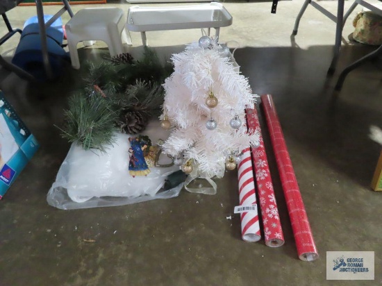 Christmas wrapping paper new in packages, miniature Christmas tree and other Christmas items