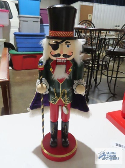 Wooden nutcracker with top hat and eye patch, approximately 15 inches tall.