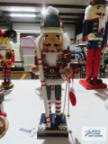 Wooden nutcracker holding skis, approximately 15 inches tall.