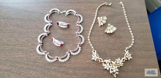 Clear stone necklace and earrings both marked Trifari and clear and red stone necklace and earrings