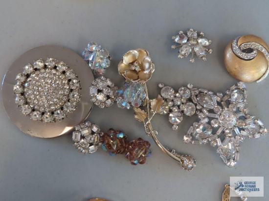 Clear gemstone pins, earrings, and pendant