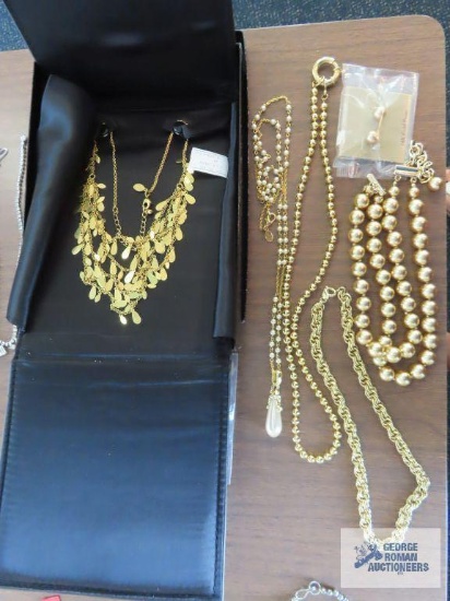 Gold multi strand necklace by Joan Rivers, pearl like and gold colored necklace by Nolan Miller,