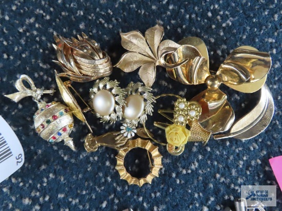 Gold colored pins. One marked Trifari