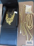 Gold multi strand necklace by Joan Rivers, pearl like and gold colored necklace by Nolan Miller,