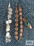 Copper colored bracelet and pin and silver colored charm bracelet