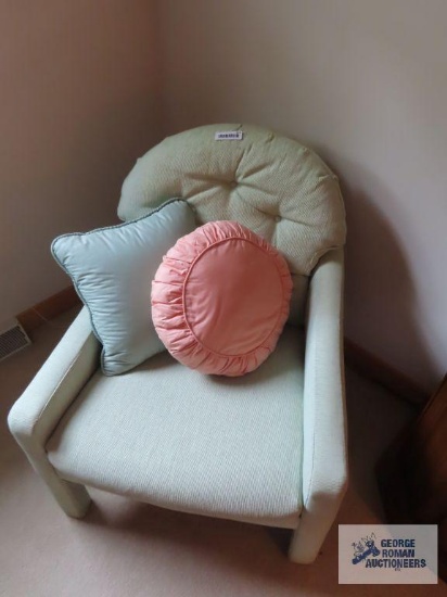pair of green armchairs with pillows on second floor