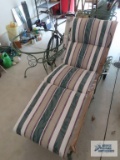 Wrought iron chaise lounge with pads and wrought iron outdoor table, missing top