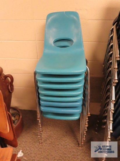 Eight light blue school chairs