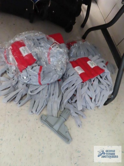 Eight red and gray mop heads