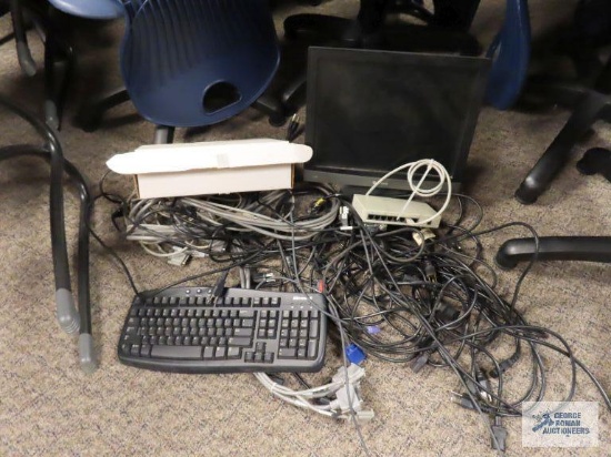 Variety of computer supplies including monitor, splitter, keyboard and cords