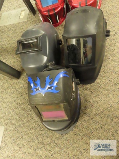 One Chicago Electric automatic welding helmet and two manual welding helmets.