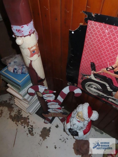 Ceramic Santa Claus, Merry Christmas wooden sign, and Santa Claus pole