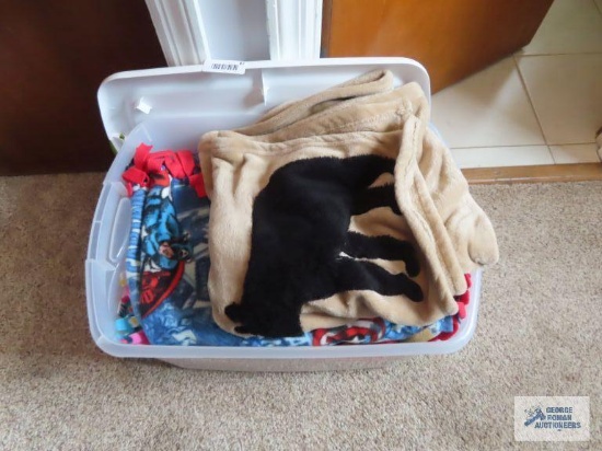 Variety of throws with plastic tote