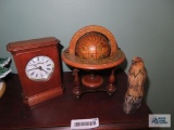 Desktop globe, clock, and carved bird figurine, beak is broken.
