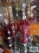 Three cranberry crystal bells. One marked made in Germany.