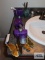 Purple bathroom set, including floral shower curtain, purple throw rug, wastebasket, soap dispenser,
