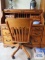 Oak roll top knee-hole desk with roll about chair made by Winners Only. On first floor.