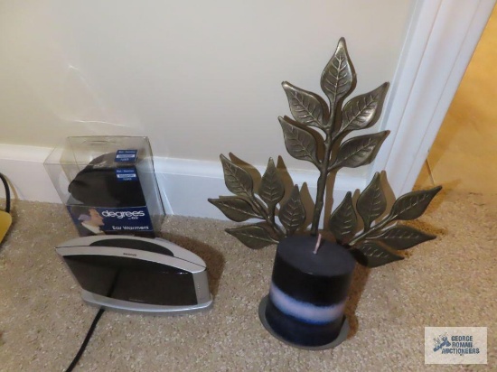 Earmuffs, digital alarm clock, and candle sconce