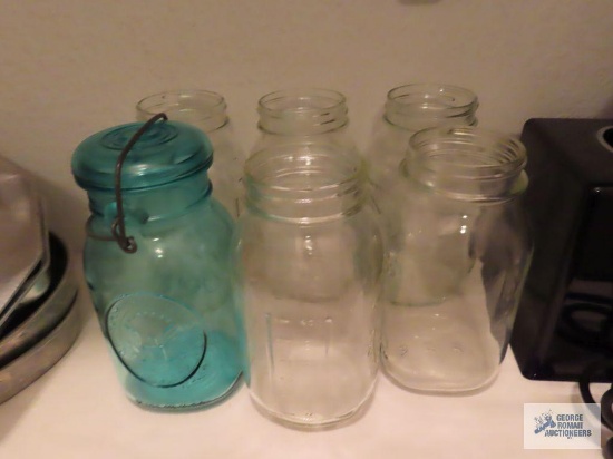 Blue canning jar with lid and other canning jars