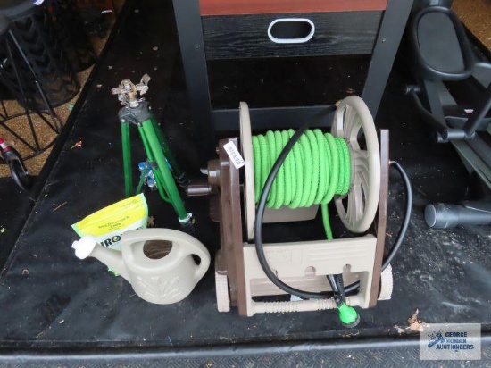 Ames garden hose reel with hose, watering can, Ironite plus, and tripod sprinkler
