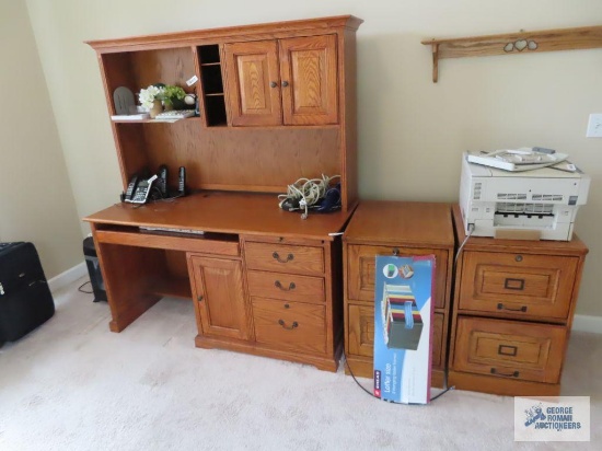 Oak heavy computer desk with hutch top and (2) two-drawer legal size filing cabinets on first floor.