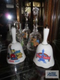 Two souvenir bells and two clear glass bells