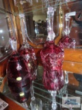 Three cranberry crystal bells. One marked made in Germany.