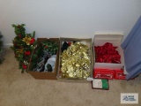 Red and gold bows, candle,florals,poinsettia, lights and Christmas dish.