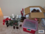 Decorative candle holders, bells, and large pine cones
