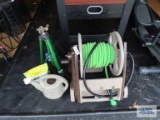 Ames garden hose reel with hose, watering can, Ironite plus, and tripod sprinkler