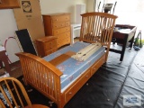 Twin size bed with trundle, nightstand, and five drawer dresser