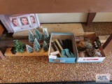 Train track pieces, fence post pieces, lights, and decorative trees.