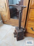Antique shoe last with accessories mounted to block of wood.