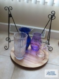 Colored and clear glass vases, plate holders, and wooden serving tray