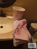 Cherry blossoms shower curtain, ceramic wastebasket, towels and soap holder. Wastebasket has a chip