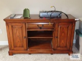 Winners Only oak flat screen TV stand on first floor.
