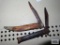 Two vintage pocket knives. Both are rusty and have damage.