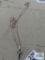 Silver colored cross pendant on silver colored chain, both marked 925.