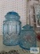 Two blue glass canisters
