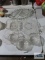 Large assortment of clear glassware including trays, celery dish, and bowls
