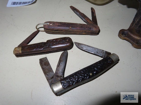Three pocket knives. All have damage.