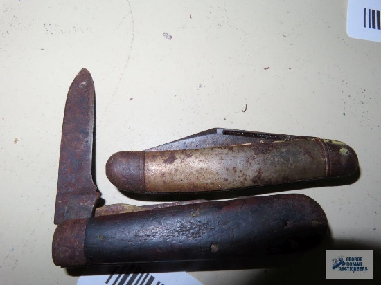 Two assorted pocket knives. Both are rusty.