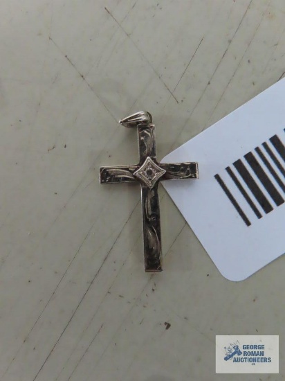 Gold colored cross etched with clear stone,marked 10K.