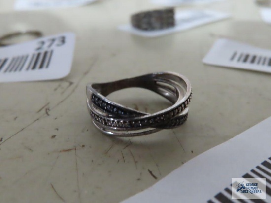 Silver colored ring with tiny clear and black stones, marked 925.