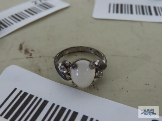 Silver colored ring with cloudy stone, marked Sterling.