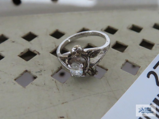 Silver colored Cupid ring with clear gemstone, marked STER.