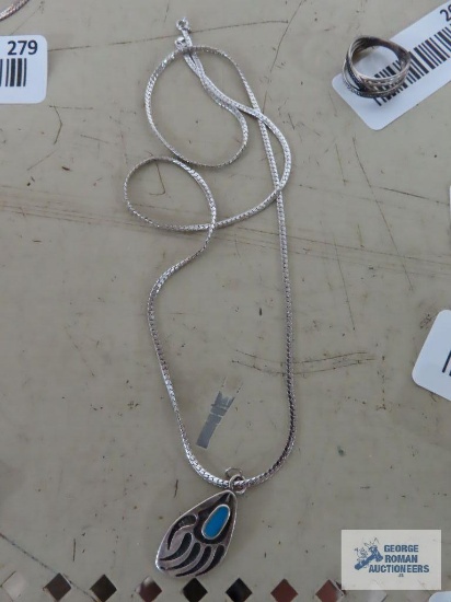 Silver colored bear paw pendant with turquoise colored stone, no marking, on silver colored chain,
