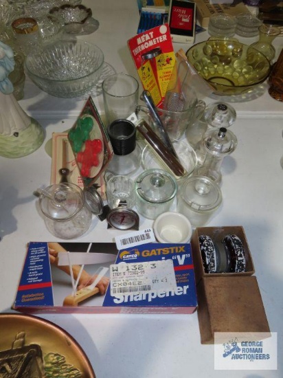 Variety of kitchen items including knife sharpener, thermometer, salt and pepper grinders, cookie